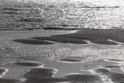 Insel Sylt Februar 2025 Ein stiller Moment am Strand während der Ebbe Insel Sylt Februar 2025 Wellen und Sonnenspiegelungen am Sandstrand bei Ebbe