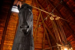 Padua Entschleunigte Fotografie Oktober 2024 Holzpferdskulptur in rustikalem Gebäude mit Holzbalkendecke