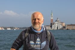 Venedig Entschleunigte Fotografie Oktober 2024 Mann steht vor venezianischer Skyline mit Gewässer im Hintergrund