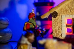 Weihnachtskrippe Villeroy und Boch - Weihnachtsdekoration Keramikfiguren bei Nacht mit Leuchtturm und beleuchtetem Haus