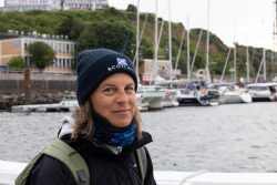 Helgolandreise August 2023 Eine Frau genießt den Blick auf einen Hafen mit Segelschiffen. Helgolandreise August 2023 Frau im Hafen mit Segelschiffen im Hintergrund