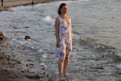 Portraitfotografie Fotoshooting Strand Helgoland August 2024 Frau im Kleid steht am Strand bei Sonnenuntergang