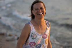 Portraitfotografie Fotoshooting Strand Helgoland August 2024 Lachende Person am Strand bei Sonnenuntergang