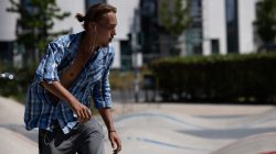 Urban Life und Streetfotografie Frankfurt Juni 2022 Junger Mann mit Kopfhörern skatet im Skatepark